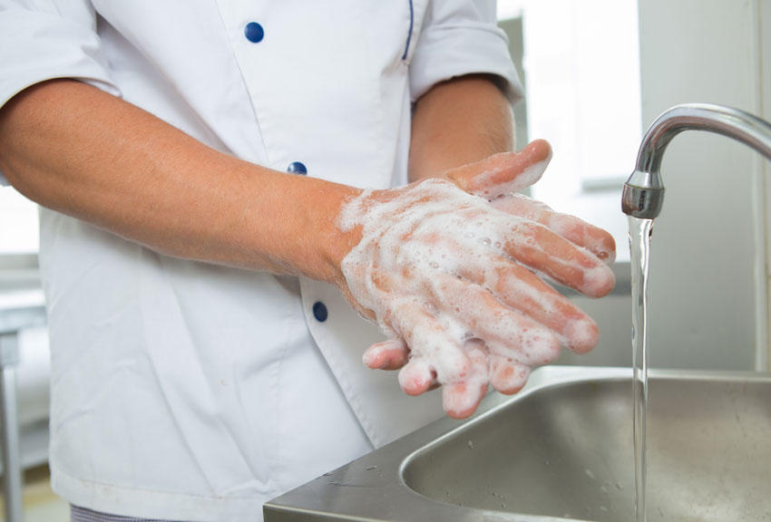 Chefs, waiters, bussers and all employees must wash hands to stop the spread of coronavirus in a restaurant.